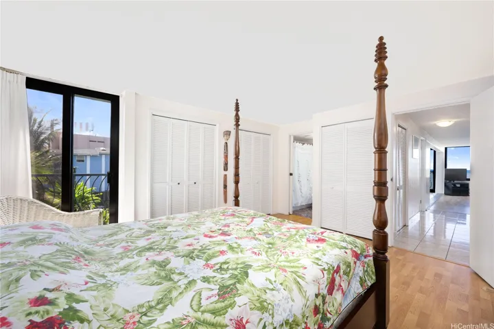 Large floor to ceiling window provides cool breezes and natural light in the main bedroom.