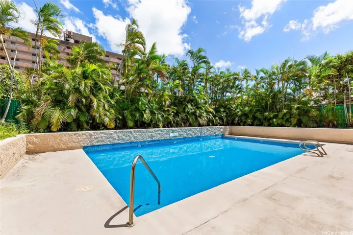 Pool surrounded by tropical landscaping