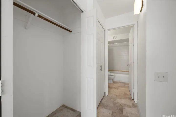 Bedroom hall with closet (1/2) and washer/dryer.