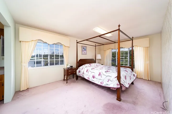 Large Primary bedroom with a walk in closet and bathroom