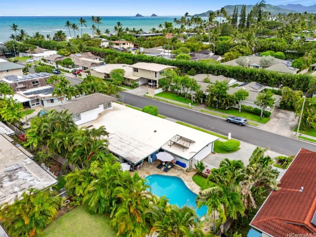 Experience the best of Kailua living in this exceptional beachside residence, ideally located just a short stroll from the ocean. This aerial view highlights the home's lush tropical setting, resort-style pool, and expansive outdoor living areas, all surrounded by mature palms and vibrant landscaping that create a private island oasis.

Beyond the property, the neighborhood offers a rare and highly desirable amenity: a residents-only gated beach access path at the end of the street. The nearby sidewalk leads directly to a private gate providing convenient access to the beach, allowing residents to enjoy swimming, kayaking, paddleboarding, beach walks, and spectacular sunrises just moments from home.