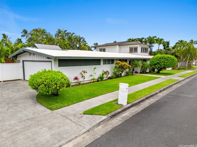 Welcome home to this impressive and meticulously maintained residence, where exceptional curb appeal and tropical landscaping create a warm first impression. Situated on a desirable sought after street,  the property features manicured lawns, mature palms, and lush island-inspired gardens that enhance both beauty and privacy. The home's distinctive design combines spacious single-level living with an expansive upstairs suite, offering flexibility for a variety of lifestyles.

A wide driveway, attractive entryway, and well-kept grounds reflect pride of ownership throughout. Surrounded by vibrant tropical foliage and located in a peaceful residential setting, this stunning home offers the perfect blend of comfort, functionality, and classic island charm.