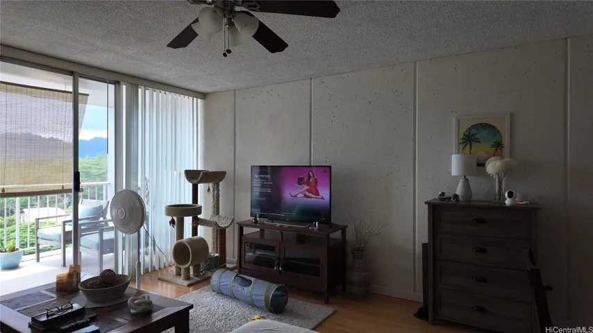 Welcome into a spacious living area with lanai access and natural light.