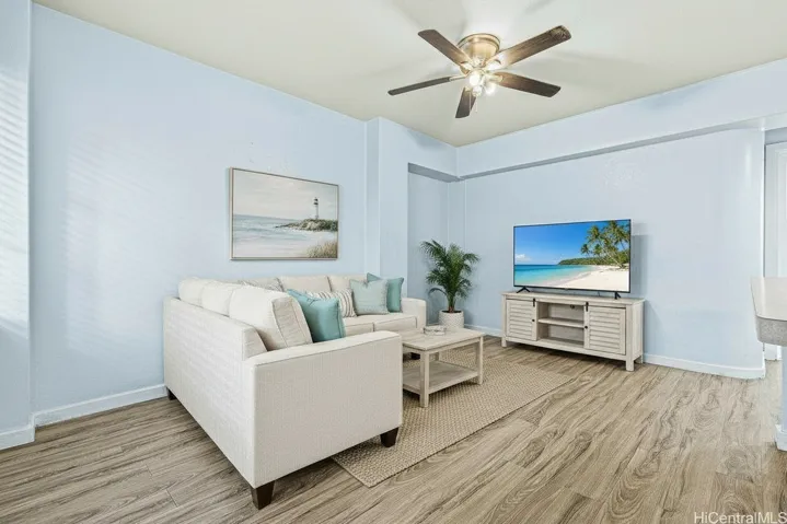Coastal-inspired living room showcasing the open layout and comfortable living space. Virtually staged and digitally enhanced.