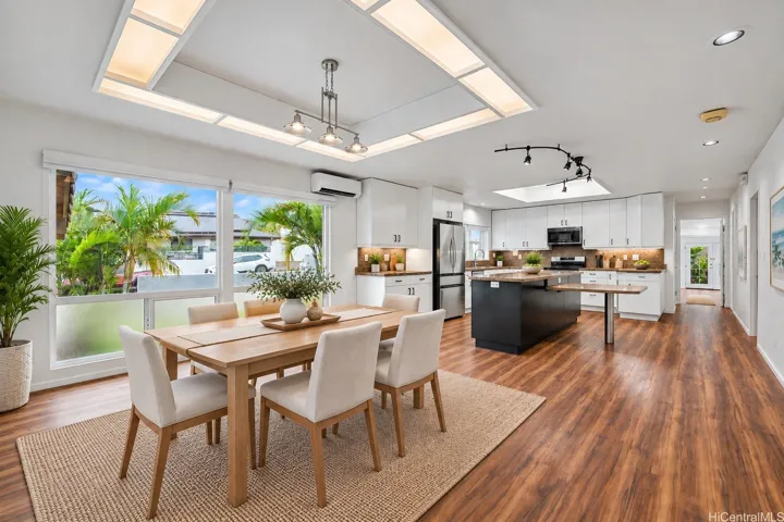 Virtually staged dining area showcasing the spacious open-concept layout and its seamless connection to the kitchen.