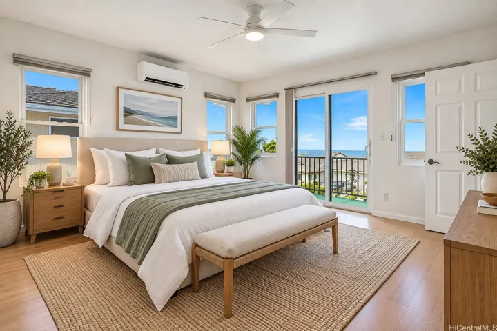 Virtually staged -Spacious primary bedroom with abundant natural light, split A/C, ceiling fan, multiple windows, and direct access to the outdoor lanai.