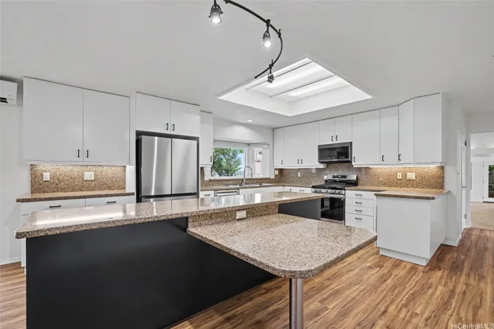 Open-concept kitchen and dining area featuring generous cabinetry and counter space, plus a convenient lower-height counter offering flexible space for seated dining, homework, workspace, or everyday use.