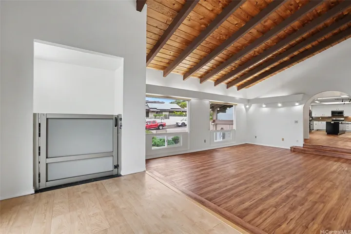Second-floor residential lift with a rated capacity of up to 750 lbs., conveniently positioned with direct access to the main living room and kitchen areas.