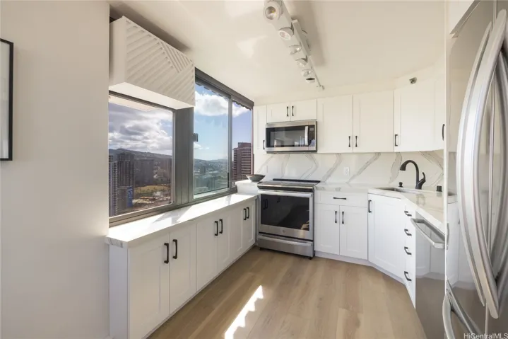 A new modern kitchen, quartz counters, lots of storage, views of Manoa Valley.