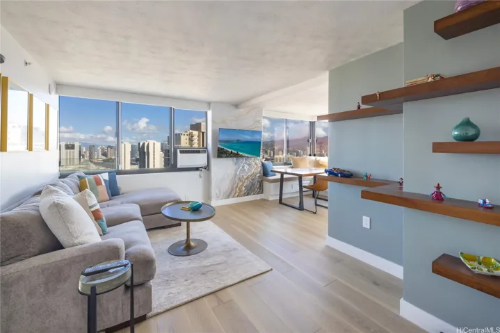 The open layout showcases modern finishes, custom built-in shelving, and a seamless flow to the dining space-perfect for entertaining or relaxing at home.
