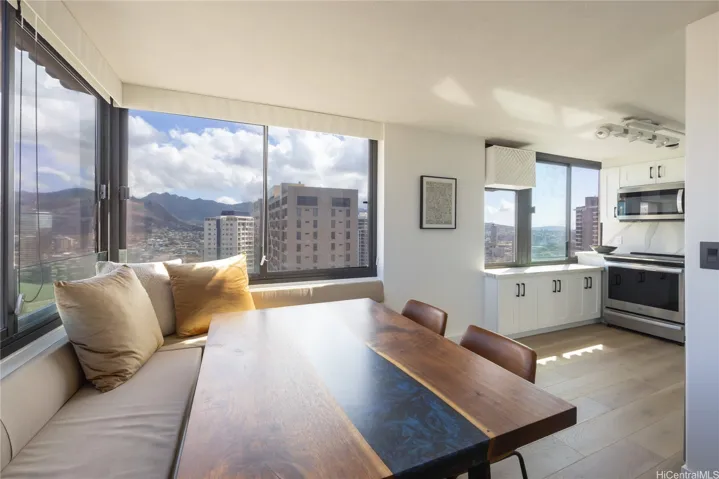 Open-concept dining and living area with abundant natural light.