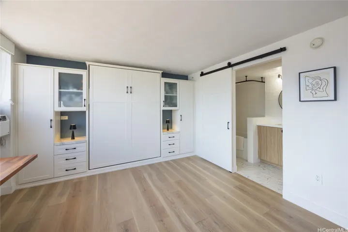 Second bedroom with murphy bed. Ideal for home office or creative studio. Custom built-ins.