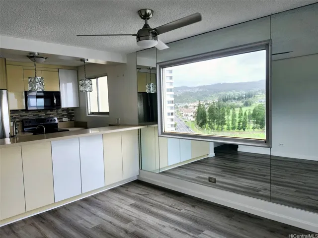 Dining area view of Golf Course. Kitchen counter has extra cabinets on the side facing the dining area