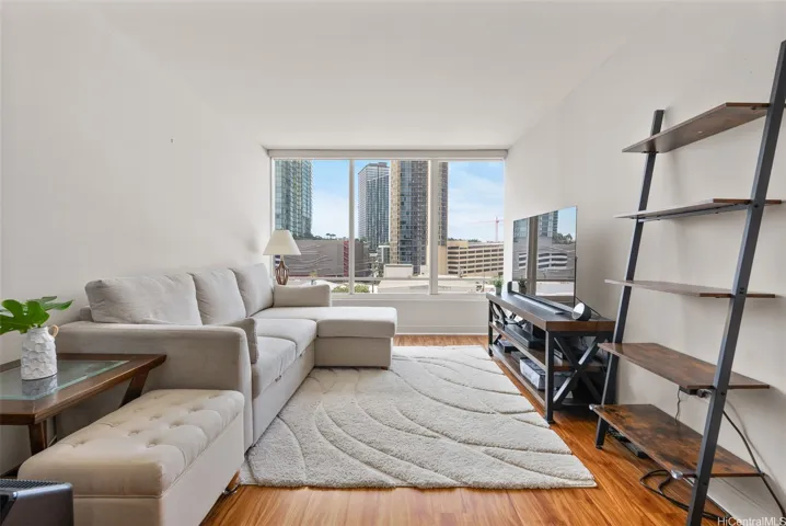Bright and airy living area featuring laminate flooring and an open, inviting feel.