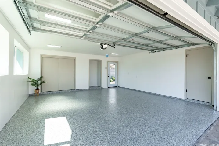 Finished two-car garage with durable epoxy flooring and additional storage.
