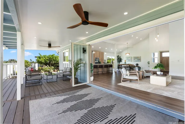 Seamless indoor-outdoor living with wide-opening doors leading to the large covered deck.
