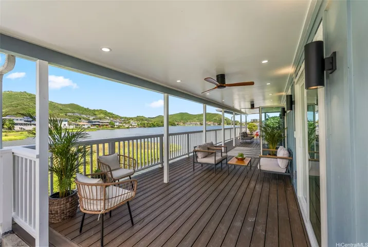 Expansive covered deck with peaceful lake and mountain views.
