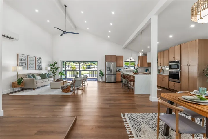 Wide-angle view showcasing the home’s expansive open-concept layout and vaulted ceilings.
