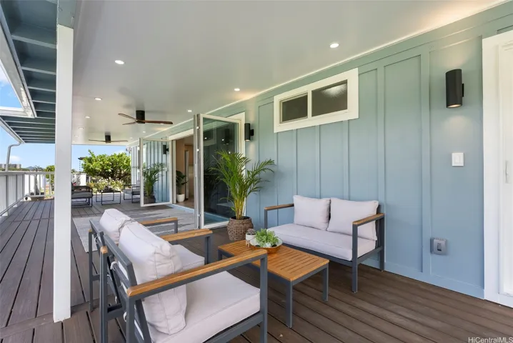 Different angle highlighting the spacious covered deck and seamless indoor-outdoor connection.

