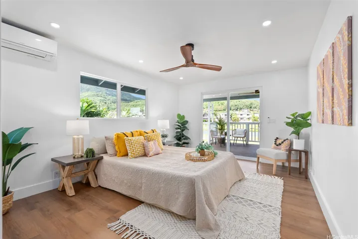 Spacious primary bedroom with sliding doors opening to the deck and peaceful lake views.
