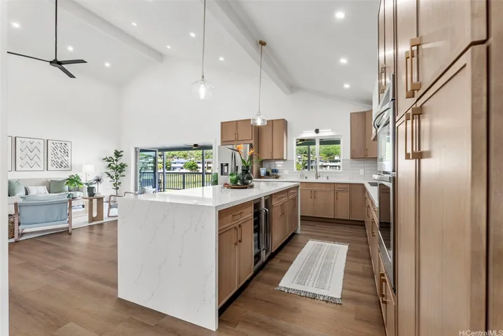Different angle showcasing the spacious kitchen, waterfall island, and seamless connection to the living area.
