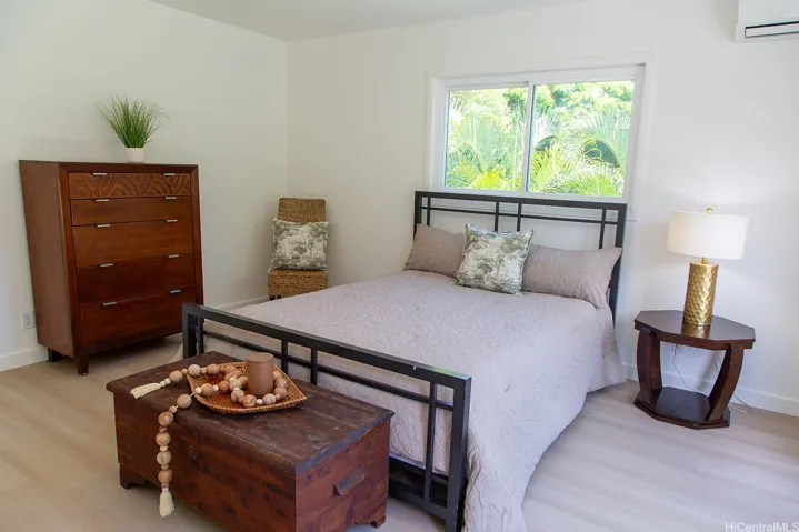 A bright, inviting primary bedroom with a private balcony just beyond, creating an easy connection to the outdoors. | Enhanced