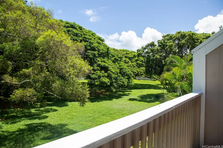 From the private balcony off the primary bedroom, enjoy a peaceful outlook over the lush community greenspace. | Enhanced