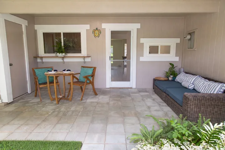 Relax or entertain outdoors with a spacious covered lanai and adjacent lawn area | Enhanced