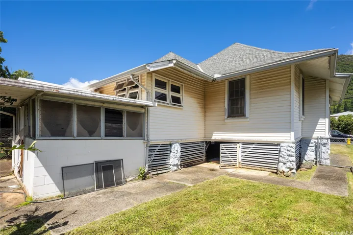 Rear exterior highlights the home's classic design and yard area.