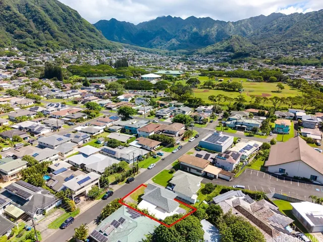 Elevated neighborhood view toward Manoa's lush mountain backdrop.