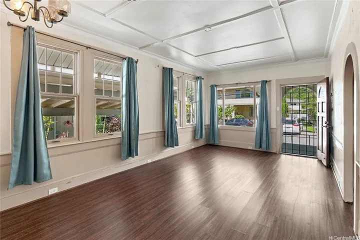 Bright living area with lots of natural light and high ceilings.