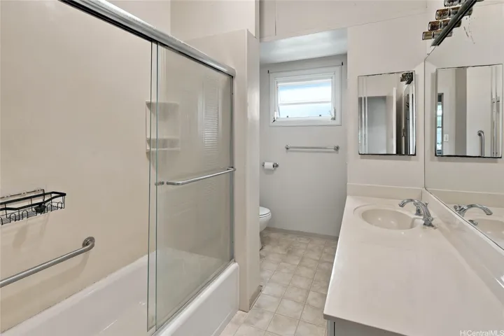 Full bathroom with tub and shower.