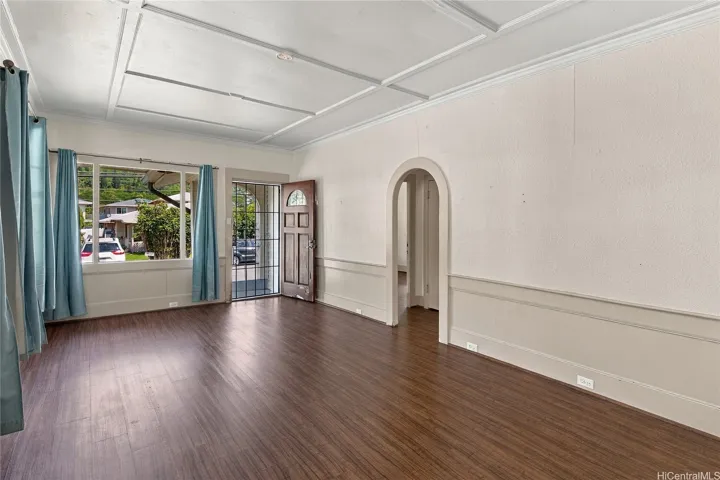 Inviting living area showcasing abundant windows and architectural details.