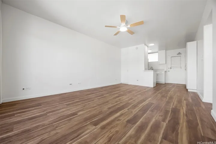An open living room adjacent to the remodeled kitchen.  Luxury vinyl flooring runs through out.