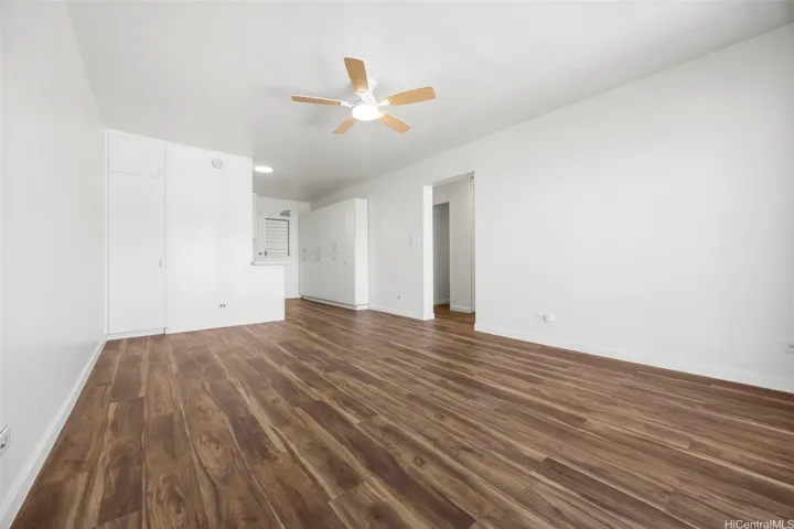 An open living room adjacent to the remodeled kitchen.  Luxury vinyl flooring runs through out.