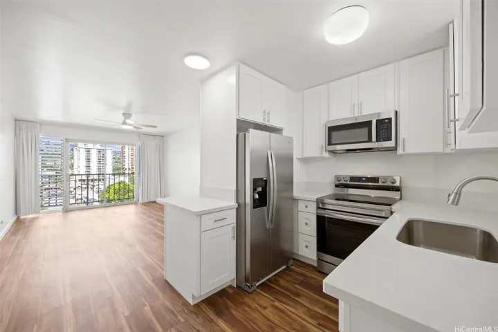 An updated kitchen with hardwood cabinetry, quartz counter tops and stainless steel appliances.  Luxury vinyl flooring runs through out.