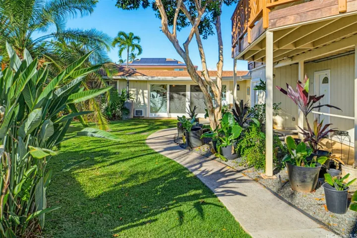 Welcoming front entry surrounded by lush landscaping