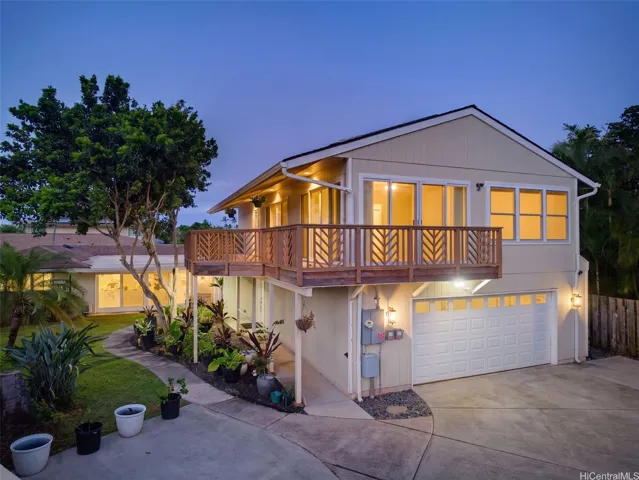 Enclosed garage with spacious driveway parking.