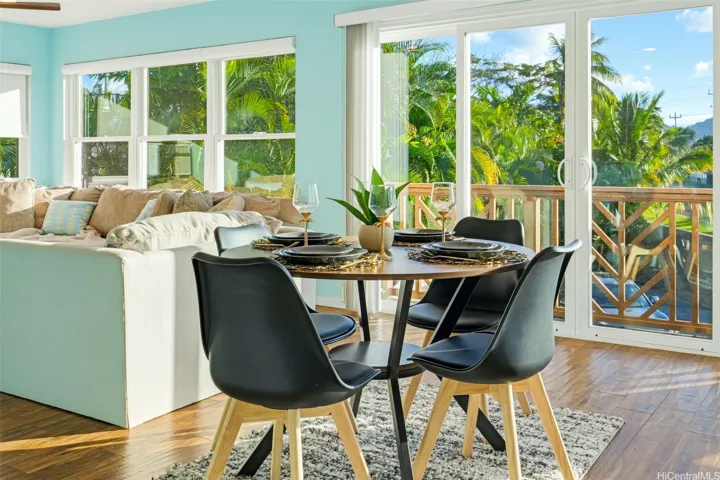 Upstairs dining area with lush views and lanai access.