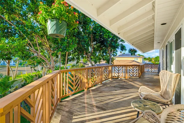 Expansive upstairs wraparound lanai with peaceful outdoor views.