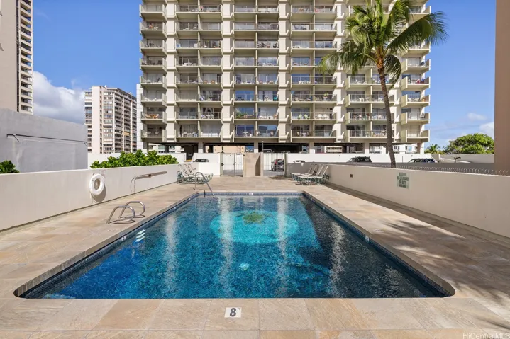 Swimming pool with apartments set back