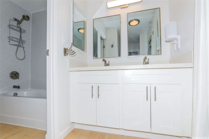Double sink and door to shower and toilet