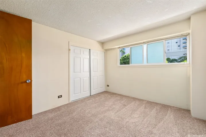 Bedroom #2 with pane windows and closet.