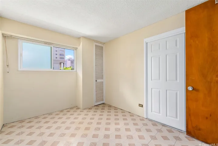 Bedroom #1 with pane window and closet.