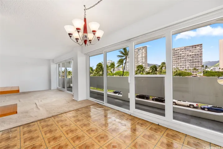 Floor to ceiling sliding windows transition from dining area to living area.