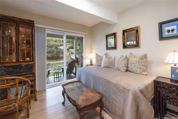 bedroom 3 has a covered lower lanai for enjoy the yard and mountain views.