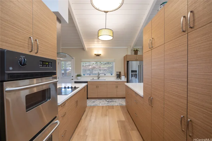 The kitchen has custom cabinetry.