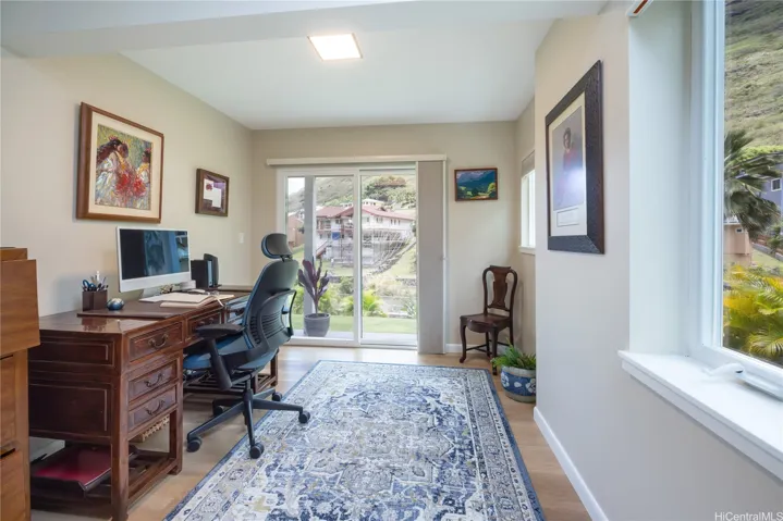 Bedroom 4, currently used as a peaceful office space, has windows on both sides to capture greenery views.