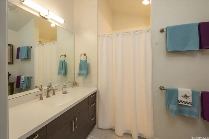 The primary bath has high ceilings and a spacious walk-in shower.