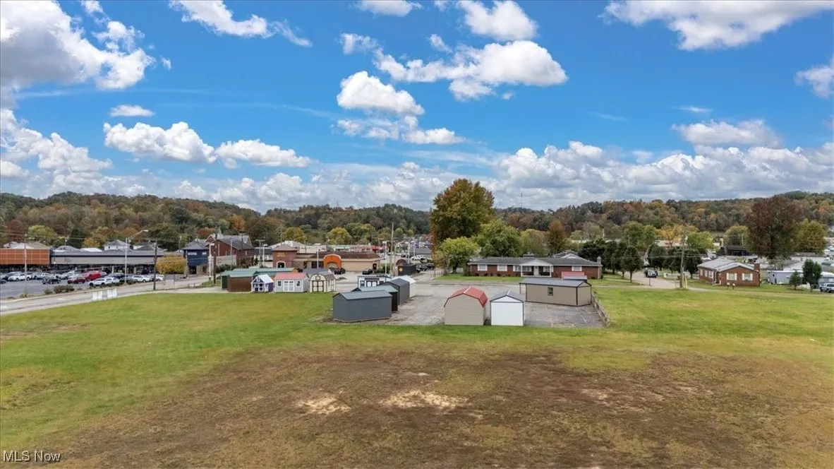 View of grassy yard with an outbuilding